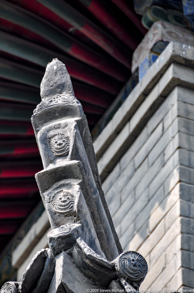 Close-up of weathered gray ceramic circular end tiles and ridge details on a traditional Chinese temple roof at Da Ci'en Temple in Xi'an.