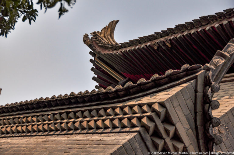 Overlapping gray-tile roofs with upturned eaves and ridge ornaments at Da Ci'en Temple in Xi'an.
