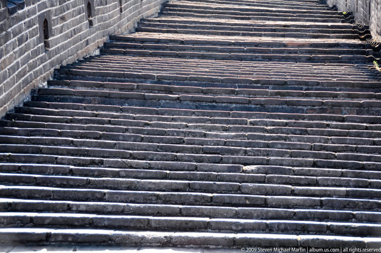 Close-up of steep, irregular stone steps on a Great Wall stairway at Mutianyu.