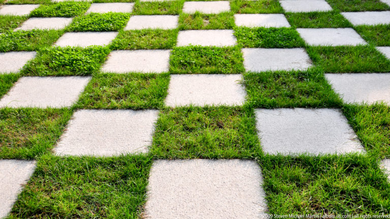 Checkerboard garden path of pale stone slabs set in green grass at the Mausoleum of the First Qin Emperor near Xi’an.