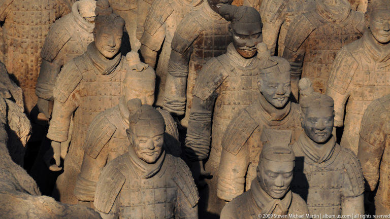Cluster of armored terracotta infantry warriors with varied faces and topknots at the Terracotta Army museum near Xi’an.