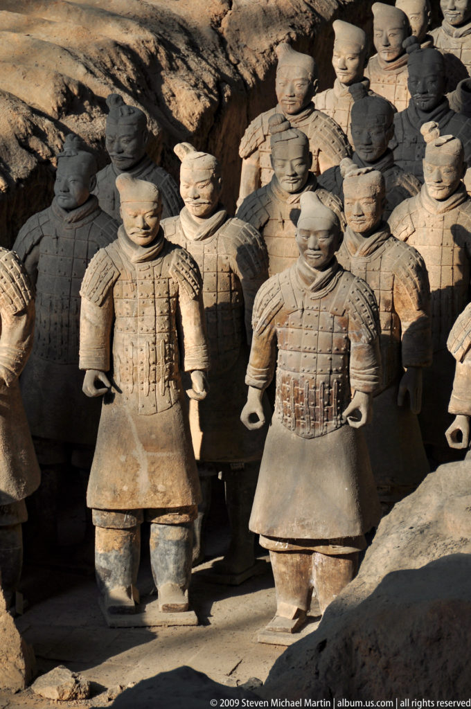 Close view of two front-rank terracotta armored warriors with laced plate armor at the Terracotta Army near Xi'an.