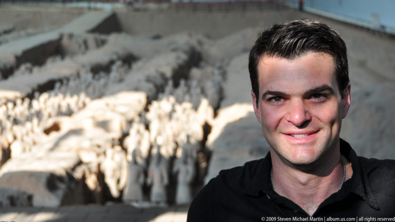 Close portrait of a male visitor inside Pit 1 hall at the Terracotta Army museum complex near Xi'an.