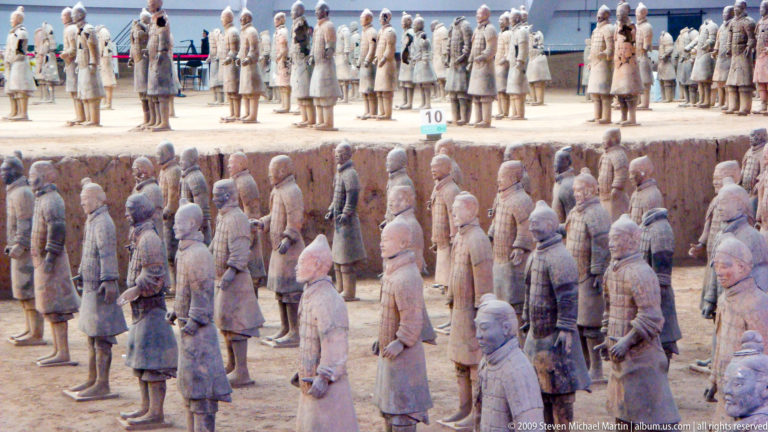 Rows of standing terracotta infantry soldiers in an excavation pit at the Mausoleum of the First Qin Emperor near Xi'an.