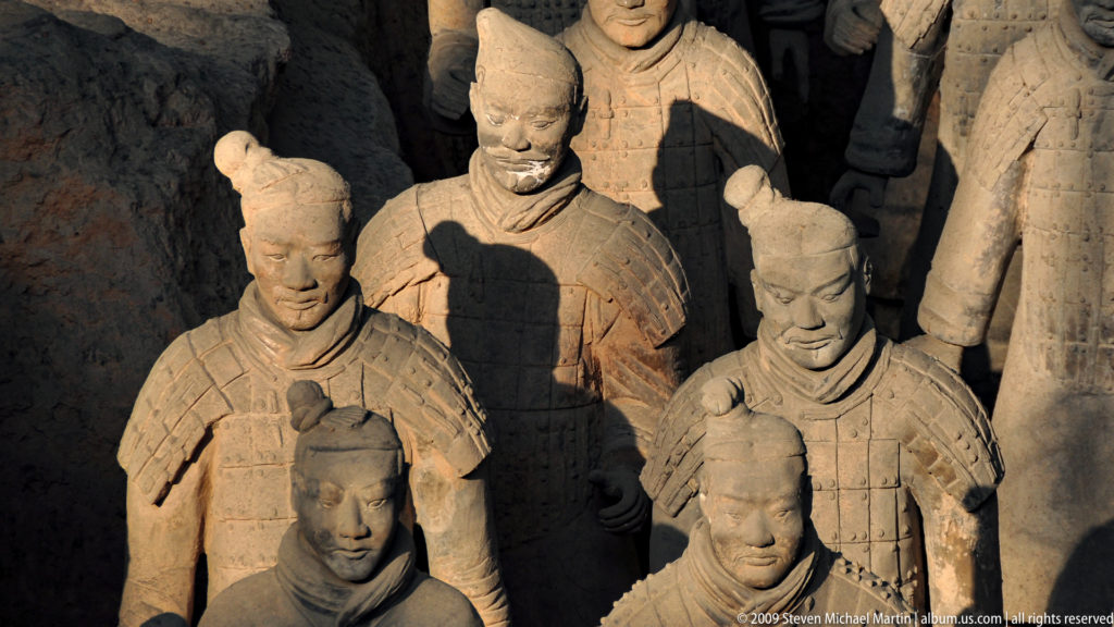 Close view of five terracotta infantry warriors, including two heavily armored figures, at the Mausoleum of the First Qin Emperor near Xi'an.