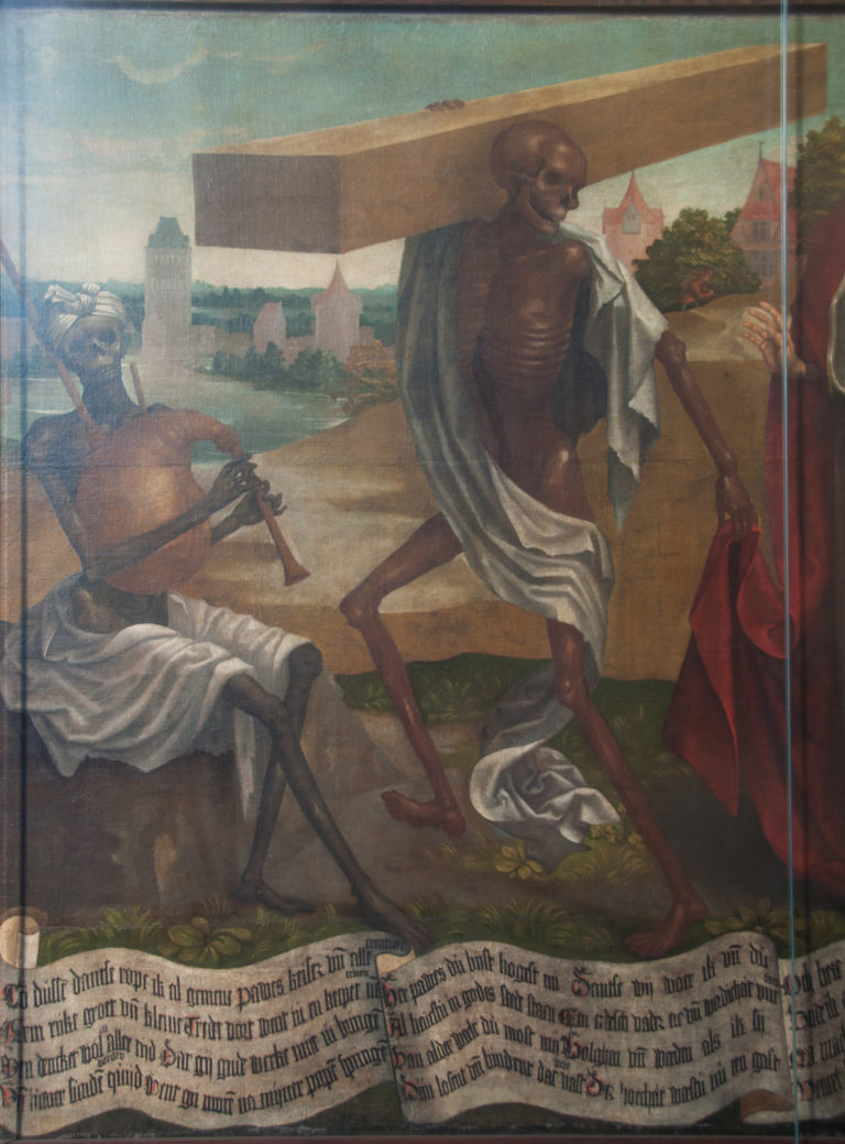 Striding skeleton draped in pale cloth in the Dance of Death, with landscape and Low German inscription visible below.