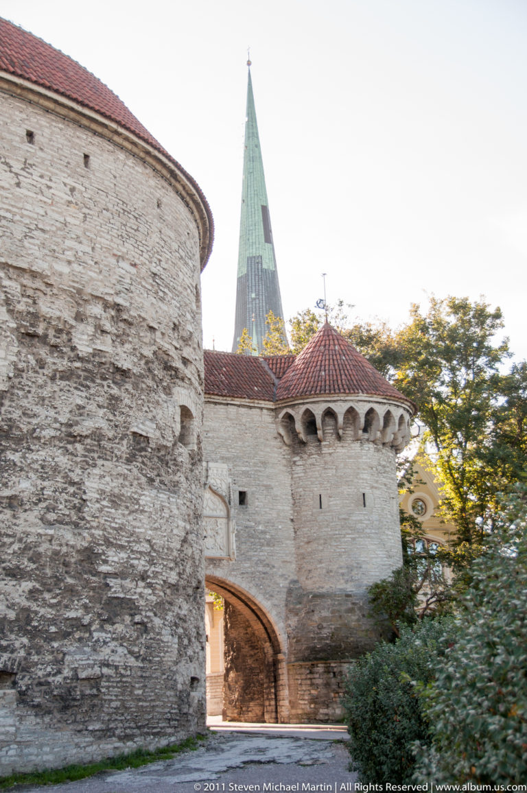 Fat Margaret and the Great Coastal Gate in Tallinn, with massive stone walls and St. Olaf’s green spire rising behind.