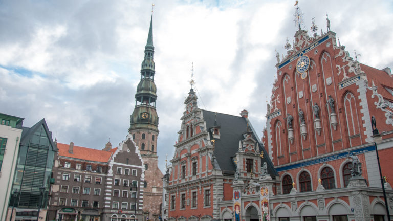 House of the Blackheads in Old Riga with its ornate red facade and St. Peter’s Church tower behind.