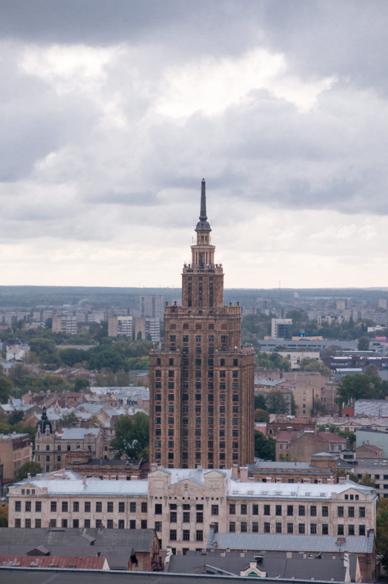 Latvian Academy of Sciences tower rising above Riga beneath a cloudy sky.