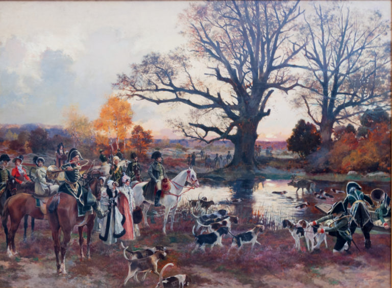 Mounted hunters and hounds gathered by a stream beneath a large leafless tree in autumn.