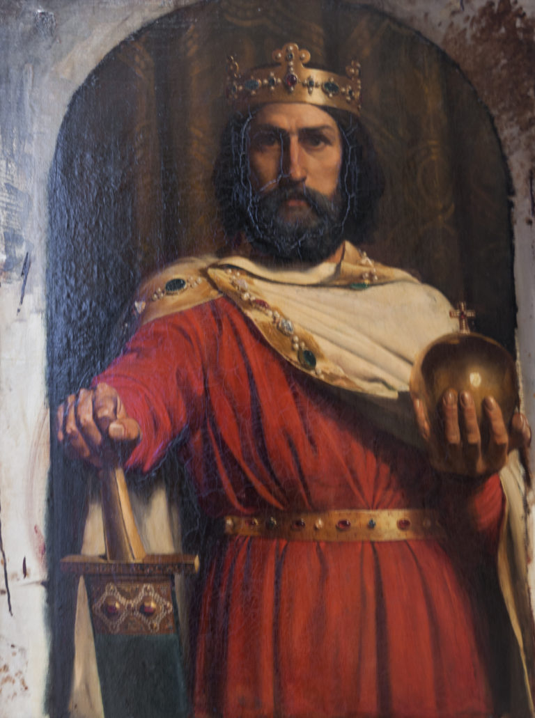 Bearded crowned king in a red robe seated with a scepter and golden orb.