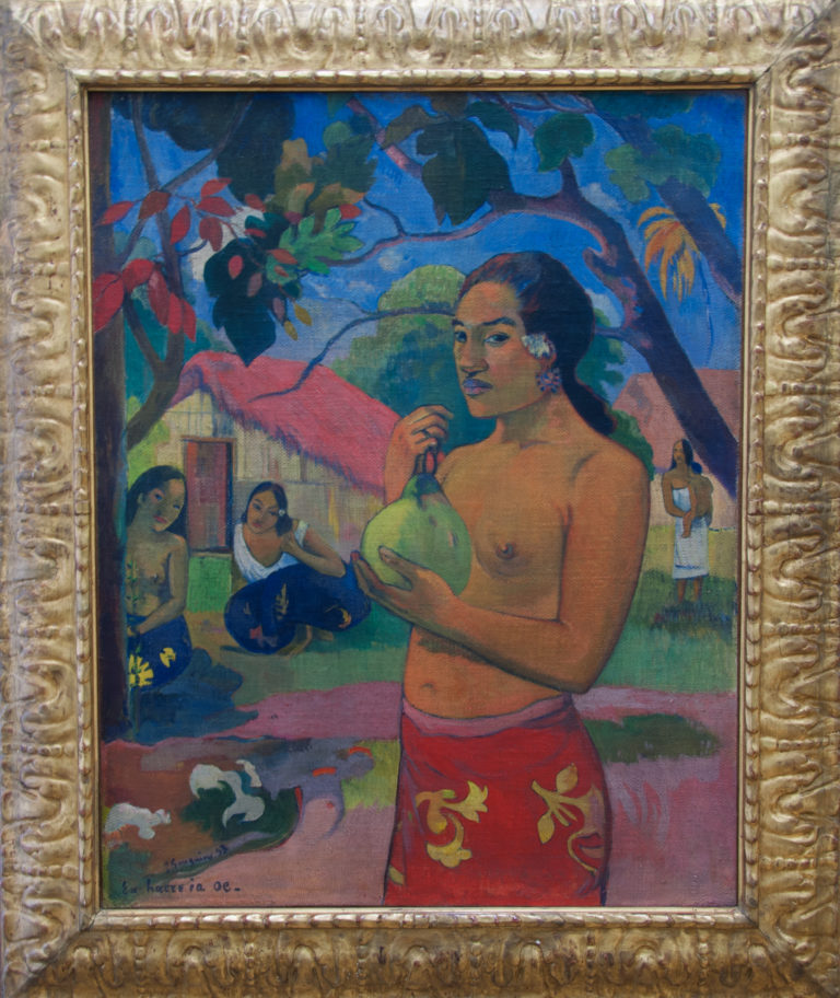 Paul Gauguin’s Eu Haere ia oe, showing a Tahitian woman holding fruit against flattened areas of vivid tropical color.