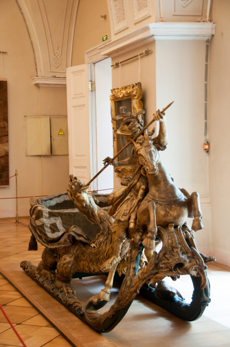 Freestanding sculptural group with a mounted figure on a rearing horse amid twisting figures and projecting forms.