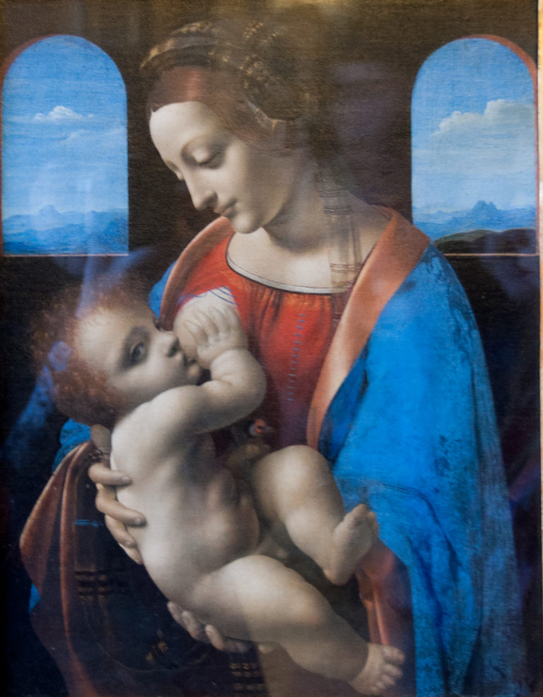 Leonardo da Vinci’s Madonna Litta, with the Virgin nursing the Christ Child before two arched openings onto a mountain landscape.