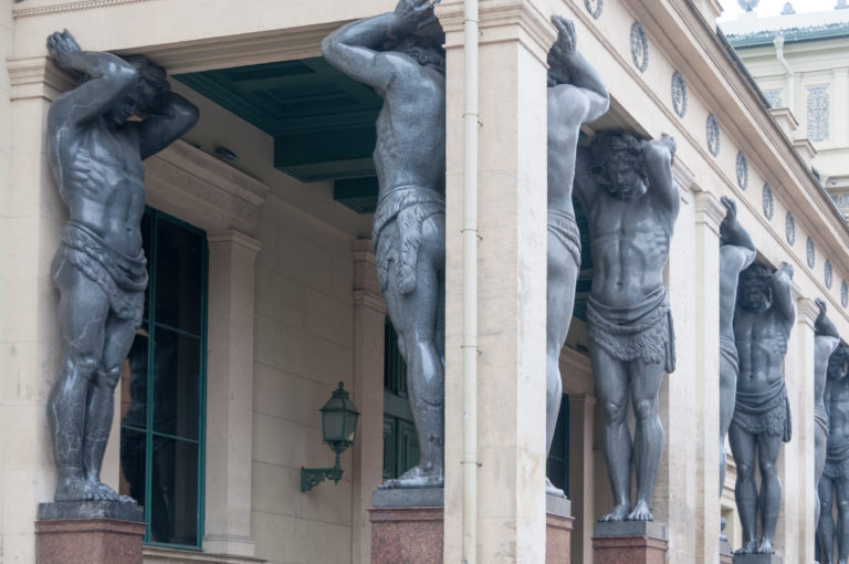Oblique view along a row of giant granite Atlas figures supporting the New Hermitage entrance portico.