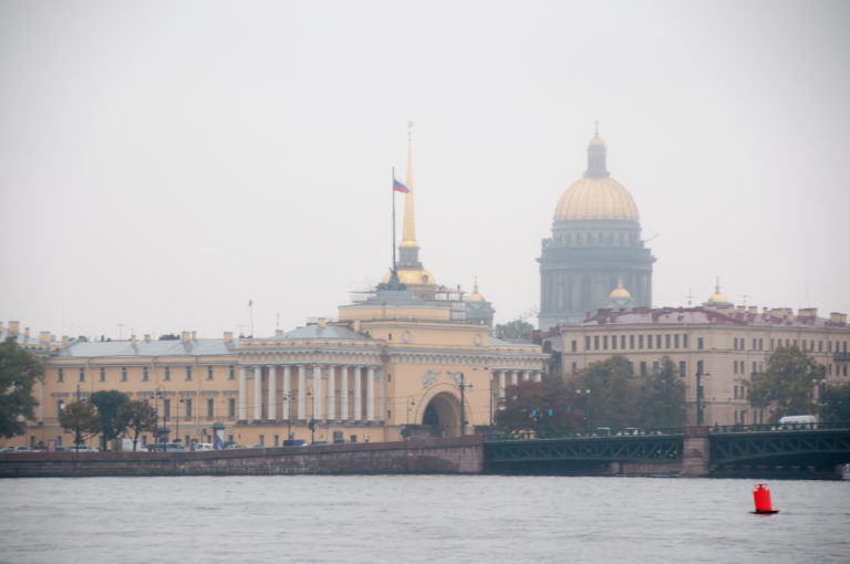 Admiralty buildings and gilded spire across the Neva with the large dome of St. Isaac’s Cathedral behind.