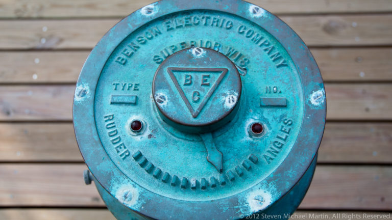 Weathered turquoise Benson Electric Company rudder control with embossed lettering and central selector.
