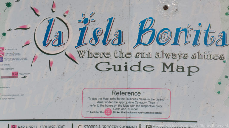 Weathered La Isla Bonita guide map sign with title lettering and visitor reference instructions.