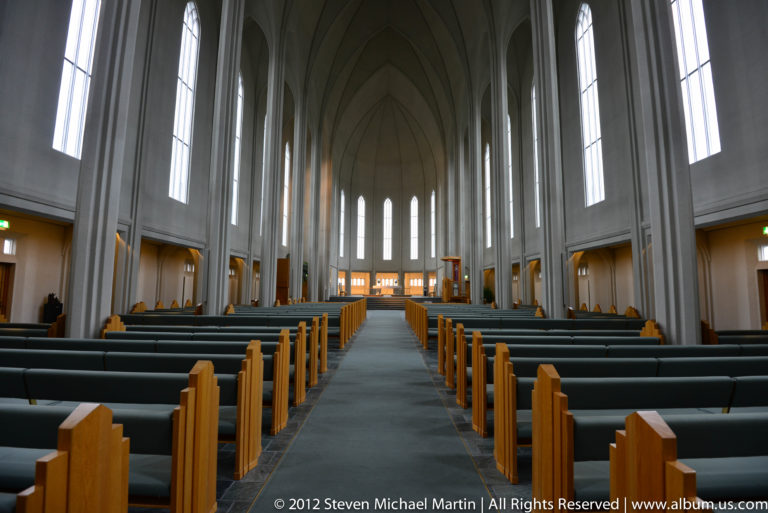 Central aisle and pale vaulted nave inside Hallgrímskirkja in Reykjavík.
