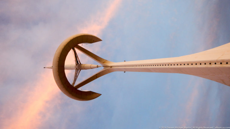 White Montjuïc Communications Tower rising against a pink and blue evening sky.