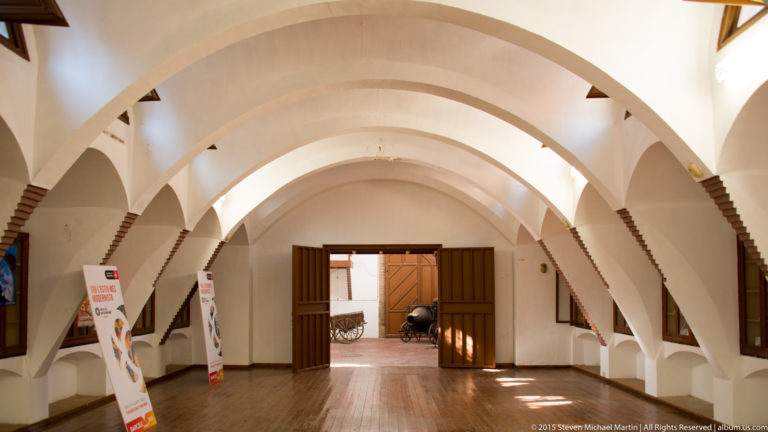 White parabolic arches repeat through the former stable interior at the Güell Pavilions.