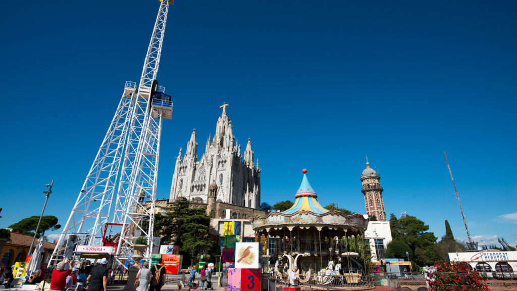 Carousel and amusement structures in front of the Temple Expiatori del Sagrat Cor at Tibidabo.