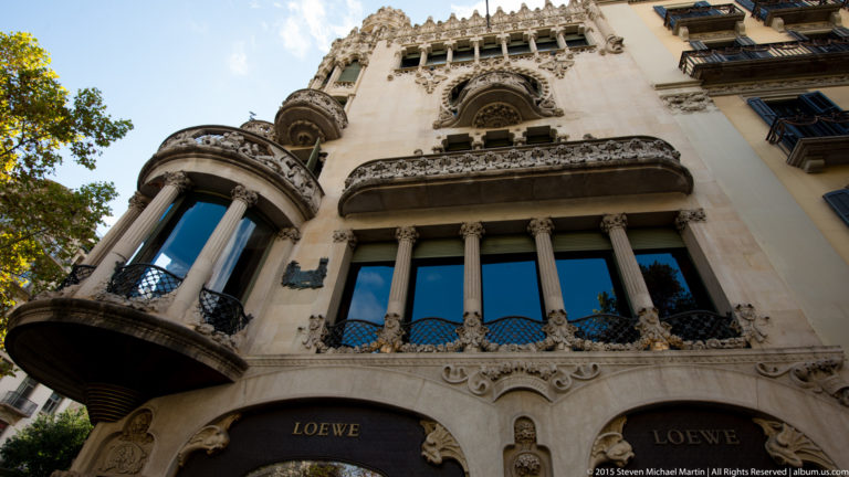 Casa Lleó Morera façade above a Loewe storefront, with carved balconies, columns, and ornate windows.