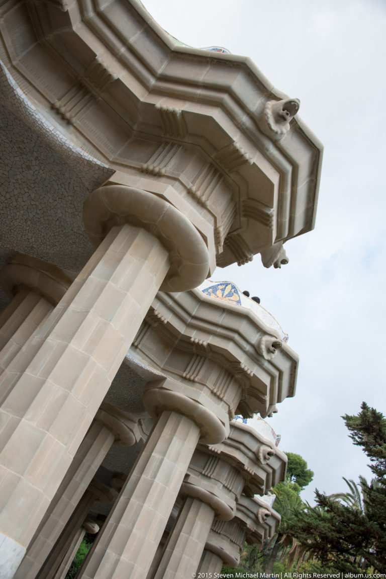 Low-angle view of massive pale columns supporting the Hypostyle Room roof at Park Güell.