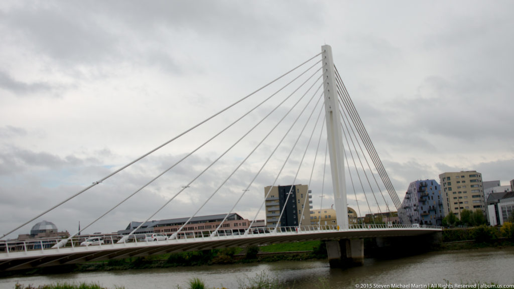 White cable-stayed bridge with a tall central pylon and fan of cables crossing the river in Nantes.