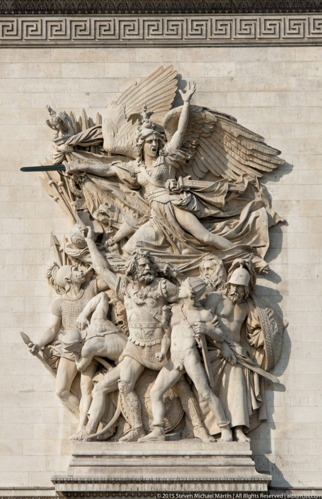 High-relief limestone group with winged Liberty raising a sword above clustered volunteers on the Arc de Triomphe.