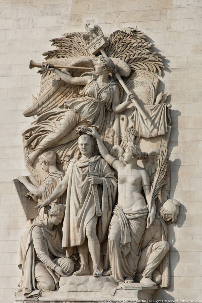 High-relief group of Napoleon and allegorical figures carved in limestone on a pier of the Arc de Triomphe.