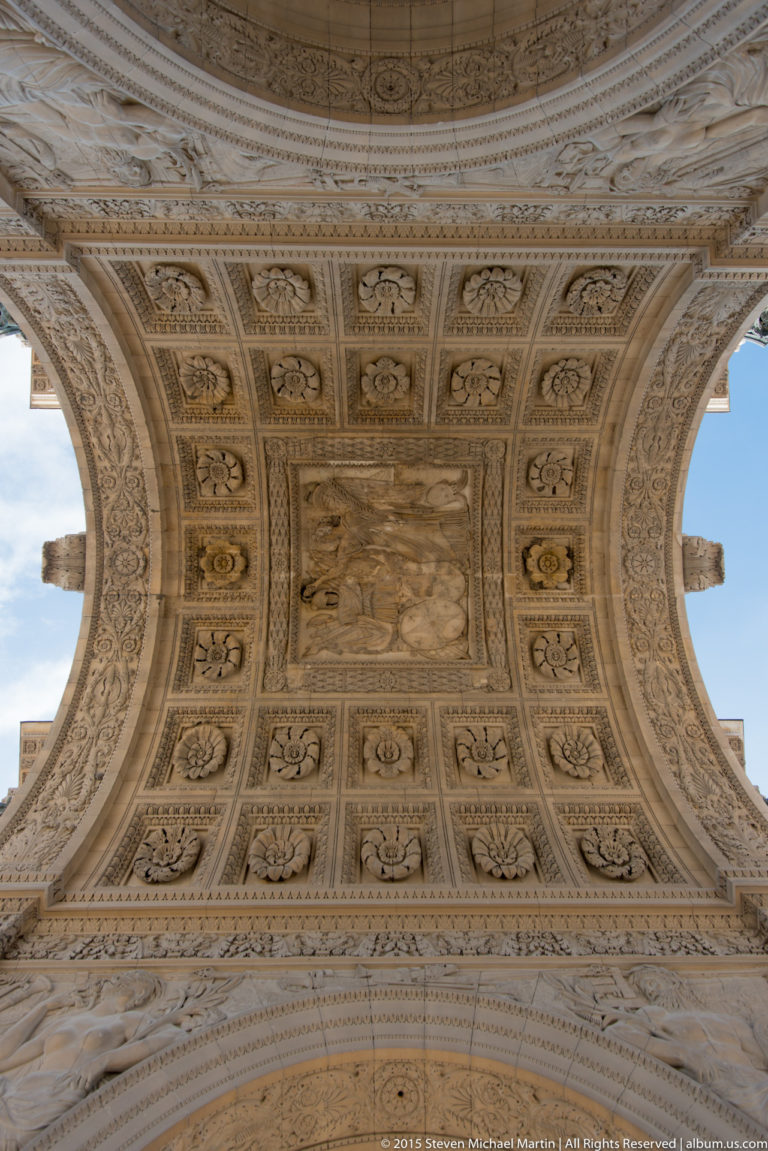 Straight-up view of the Arc de Triomphe du Carrousel vault with square coffers, floral rosettes, carved borders, and central relief.