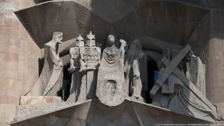 Angular stone figures by Josep Maria Subirachs in a recessed sculptural group on the Sagrada Família Passion façade.