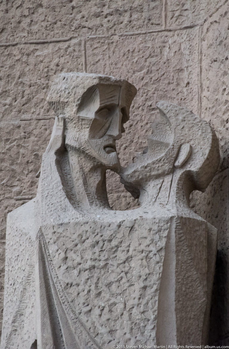 Pontius Pilate bending over a basin in Subirachs’s hand-washing scene on the Sagrada Família Passion façade.