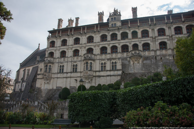Renaissance façade of the Château Royal de Blois with multi-level exterior stair tower, arcades, and dormers.