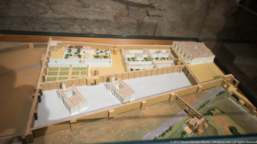 Overhead view of an architectural model reconstructing courtyards, roofed halls, walls, and service spaces of the Caliphal Baths.