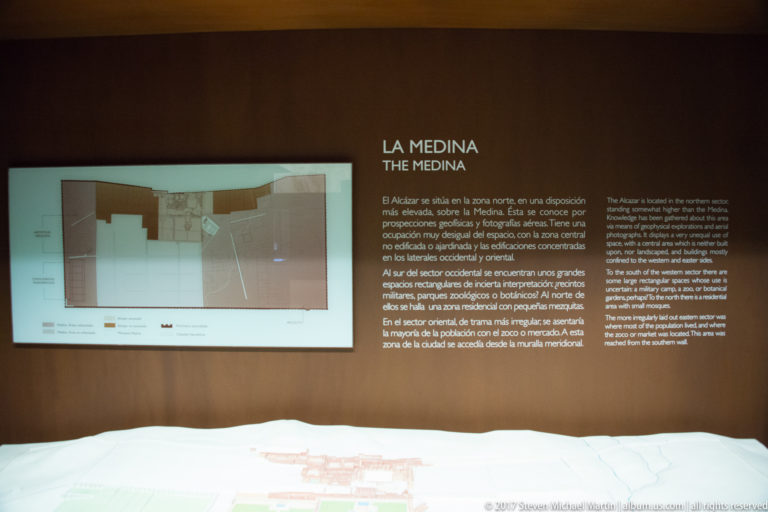 Visitor-center display headed La Medina / The Medina with bilingual text, a site plan on the wall, and a large model below.