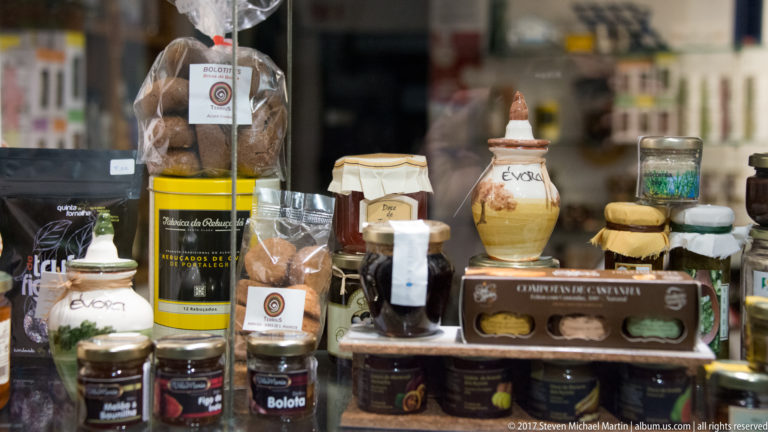 Shop display of jars, packets, ceramics, and boxed regional food products associated with Évora and the Alentejo.