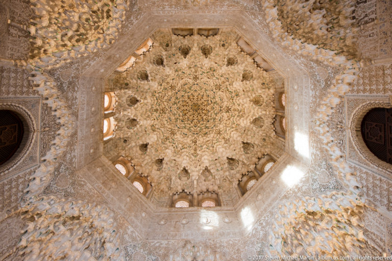 Eight-pointed muqarnas dome of the Sala de los Abencerrajes, with layered plaster cells and small windows around its base.