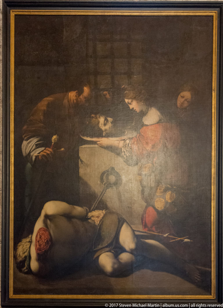 Dark dramatic painting with a fallen half-clothed figure below several men engaged in a violent scene above.