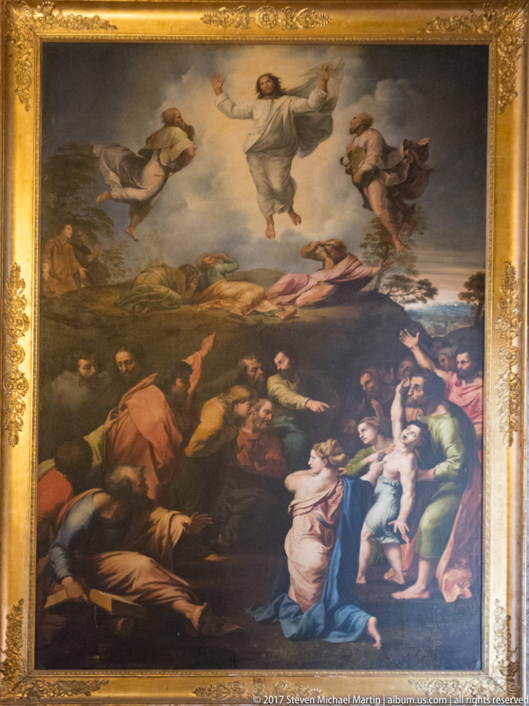Large gilded religious painting of Christ ascending above disciples and angels, with figures gesturing upward from the ground below.