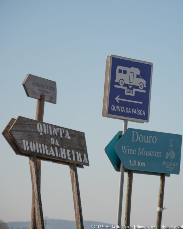 Roadside direction signs pointing to Quinta da Faísca, Douro Wine Museum, and Quinta da Boirralheira.