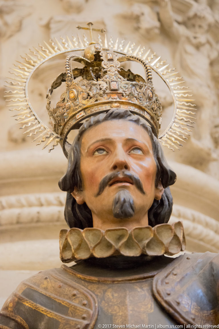 Close-up of a crowned bearded male religious figure with ornate halo, jeweled crown, and elaborate collar.
