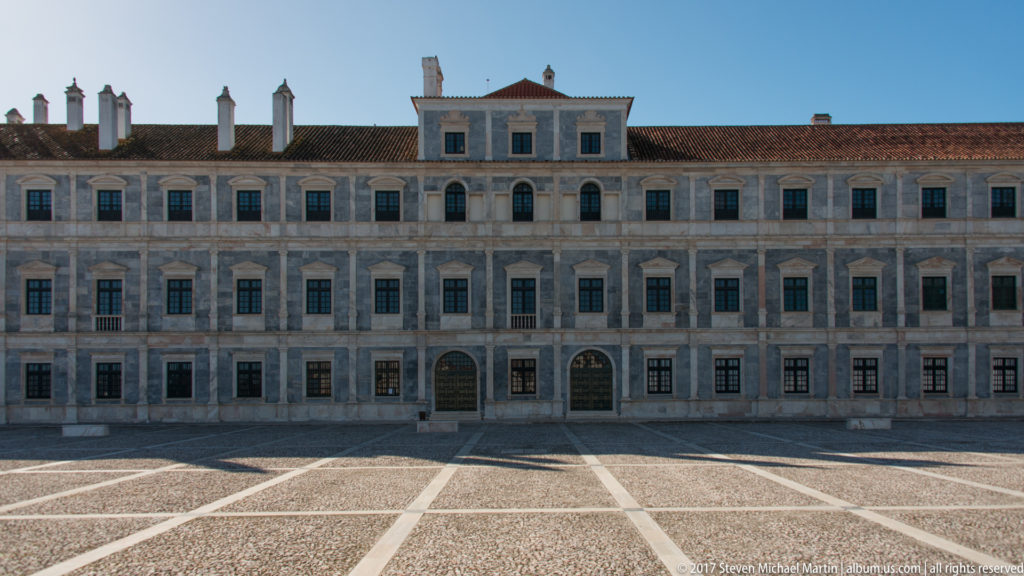 Symmetrical central section of the Ducal Palace with rows of dark windows, pale marble bays and two ground-floor portals.