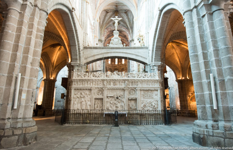 Pale stone Renaissance retrochoir in Ávila Cathedral, densely carved with biblical reliefs and Plateresque ornament.