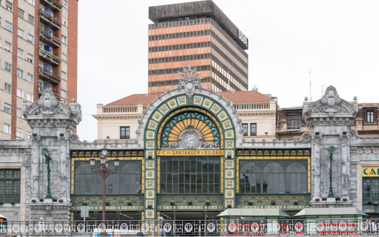 Ornate Bilbao-Concordia station façade with a large colored arched window and the words “F-C DE SANTANDER A BILBAO.”