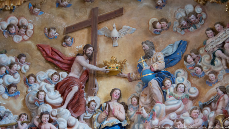 Christ crowns the Virgin Mary amid clouds, angels, cherubs, a cross, and the dove of the Holy Spirit.