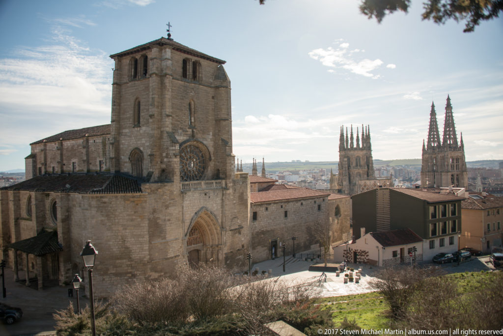 Church of San Esteban in the foreground with the twin openwork spires of Burgos Cathedral rising behind.