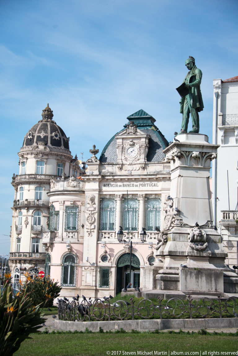 Joaquim António de Aguiar monument before the ornate Banco de Portugal building at Largo da Portagem in Coimbra.