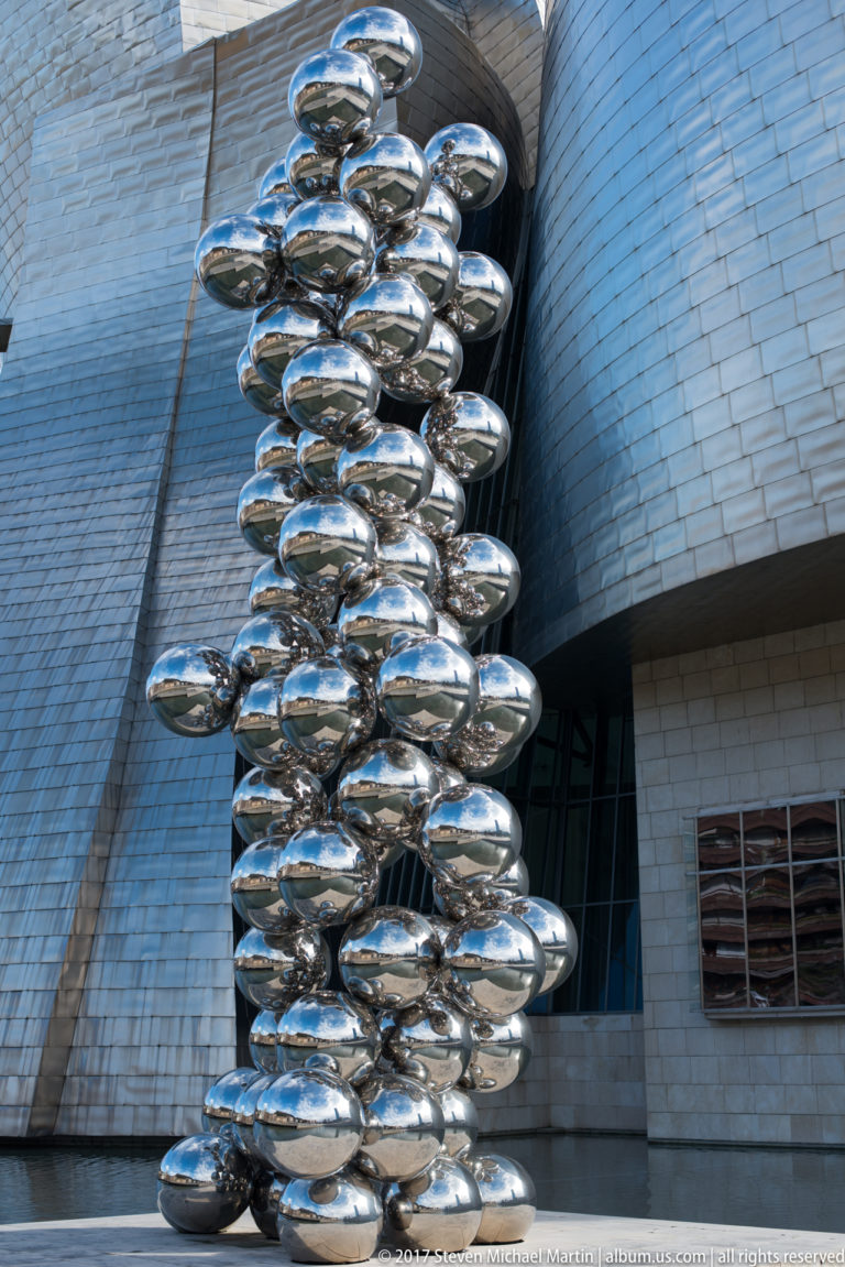 Tall column of polished stainless-steel spheres forming Anish Kapoor’s Tall Tree & The Eye beside the Guggenheim Museum Bilbao.